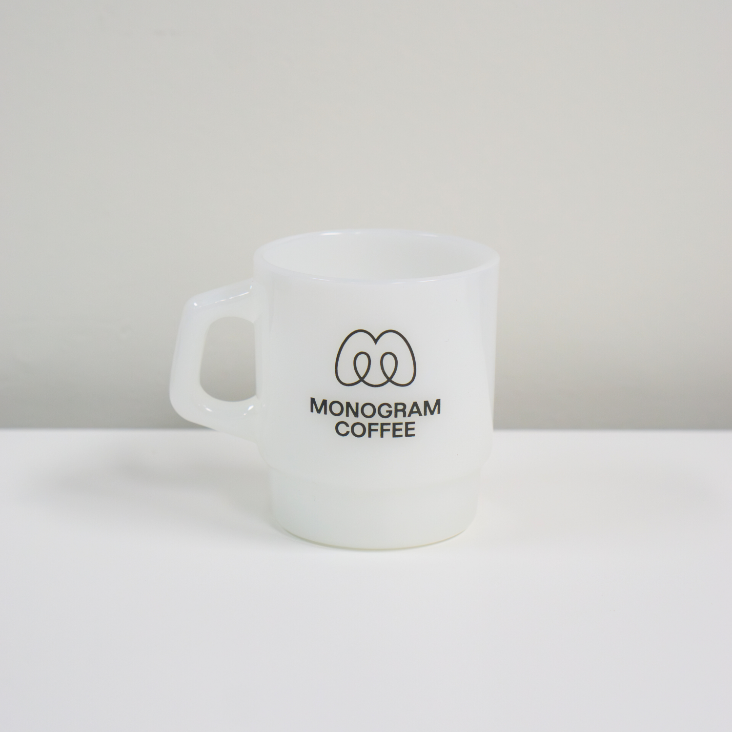 White mug with 'Monogram Coffee' logo on a white background
