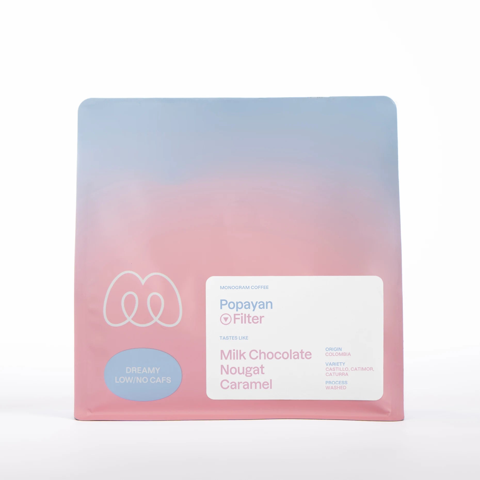 A blue and pink gradient bag of Monogram Popayan filter coffee, a washed decaf from Colombia (Castillo, Catimor, and Caturra varieties) with tasting notes of milk chocolate, nougat, and caramel.