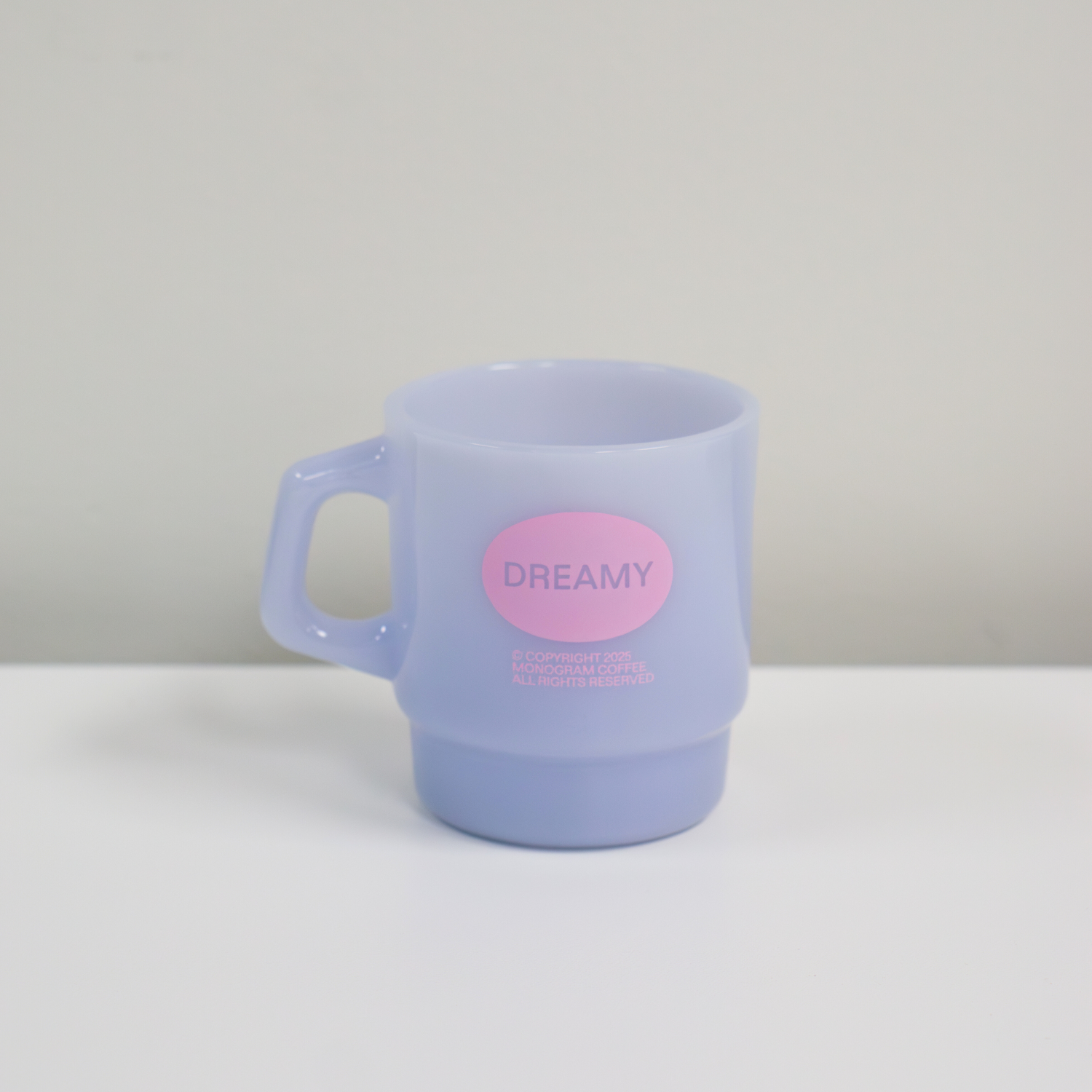 Pastel purple mug with a pink label on a white surface