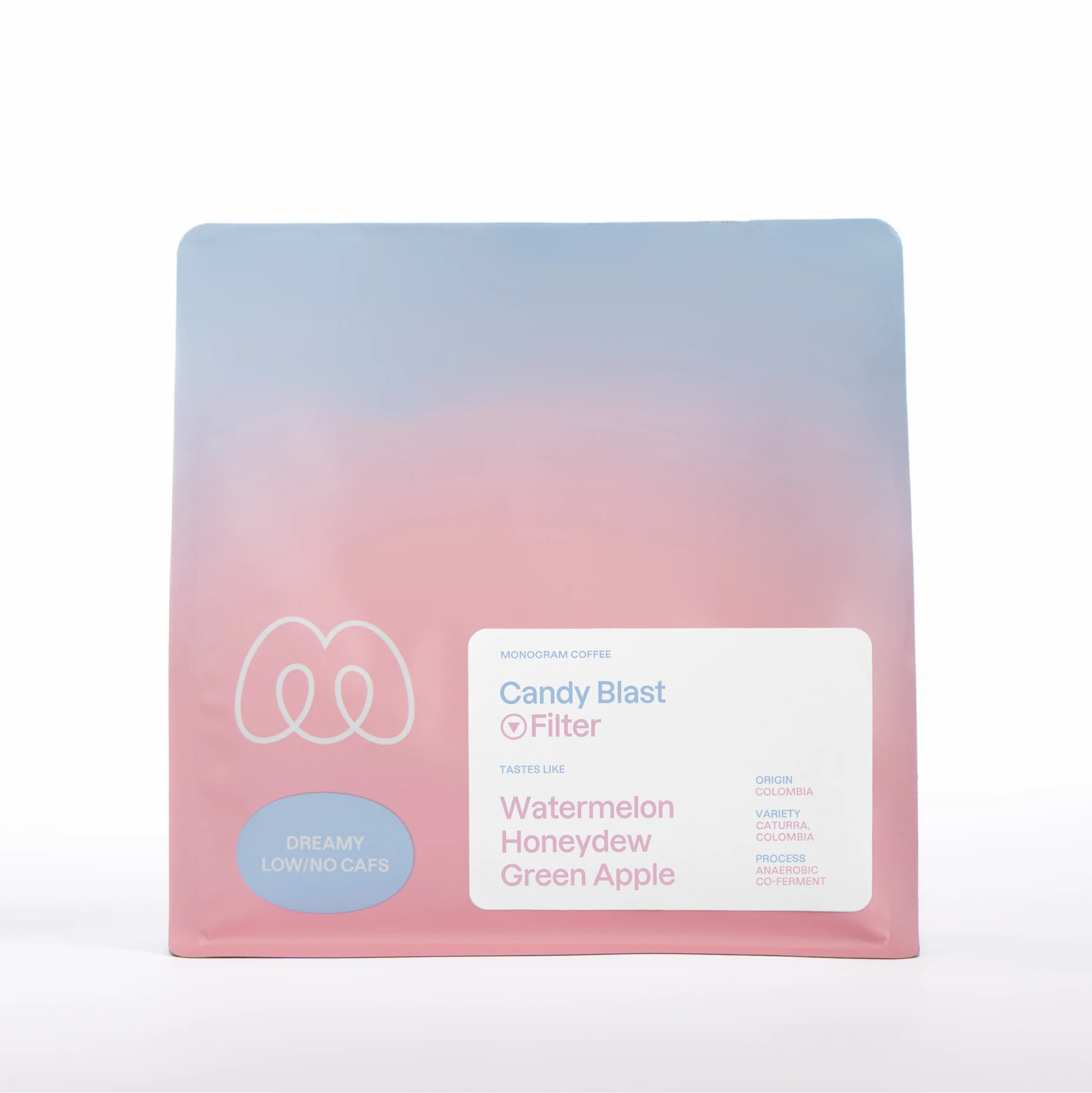 A blue and pink gradient bag of Monogram Candy Blast decaf filter coffee, an anaerobic co-ferment from Colombia (Caturra and Colombia varieties) with tasting notes of watermelon, honeydew, and green apple.